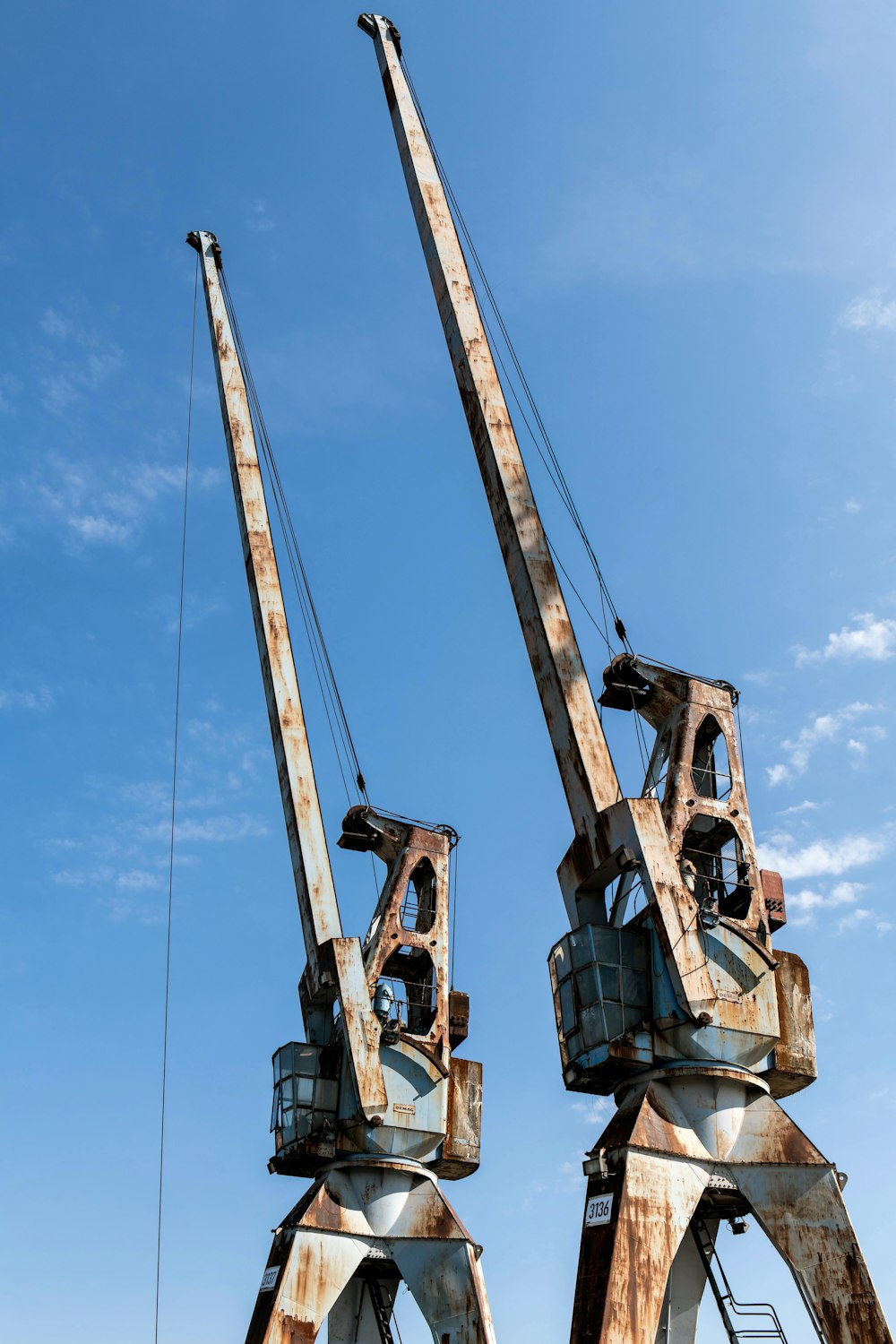 a couple of large cranes sitting on top of a field