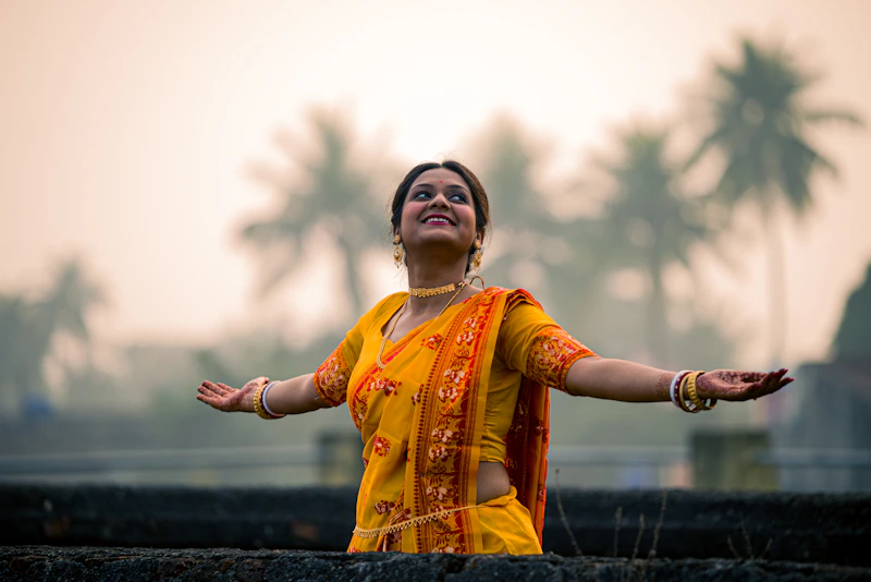 Graceful Indian sugar mama practicing yoga in a yellow sari