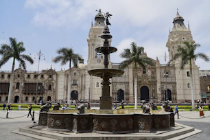 a large building with a fountain in front of it