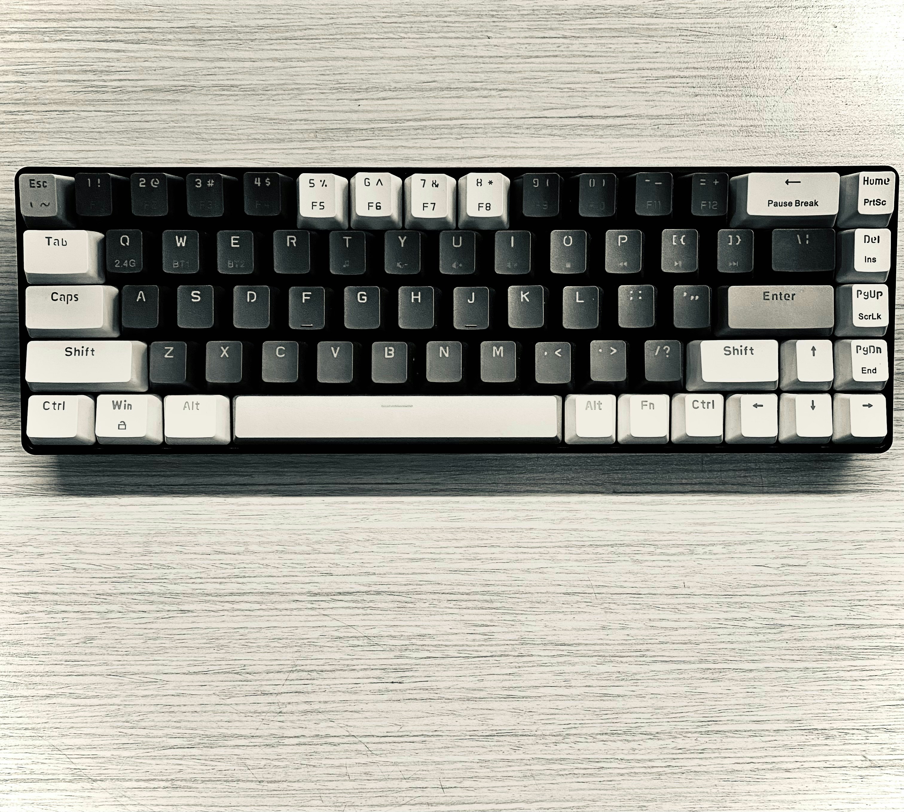 a computer keyboard sitting on top of a wooden table