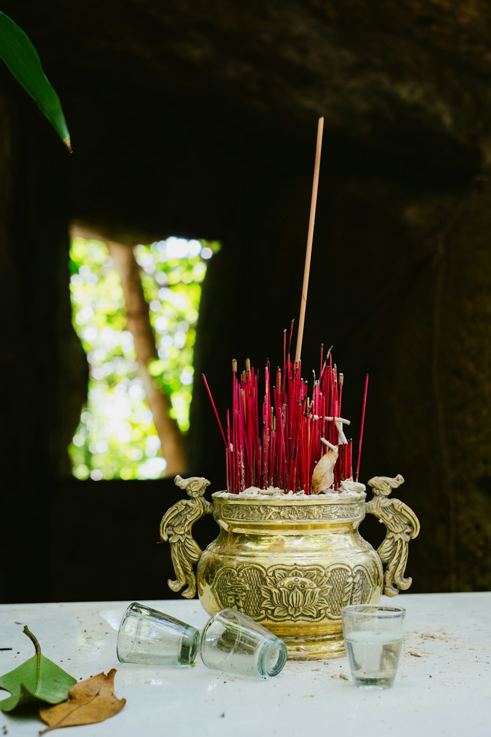 a vase filled with red candles sitting on top of a table