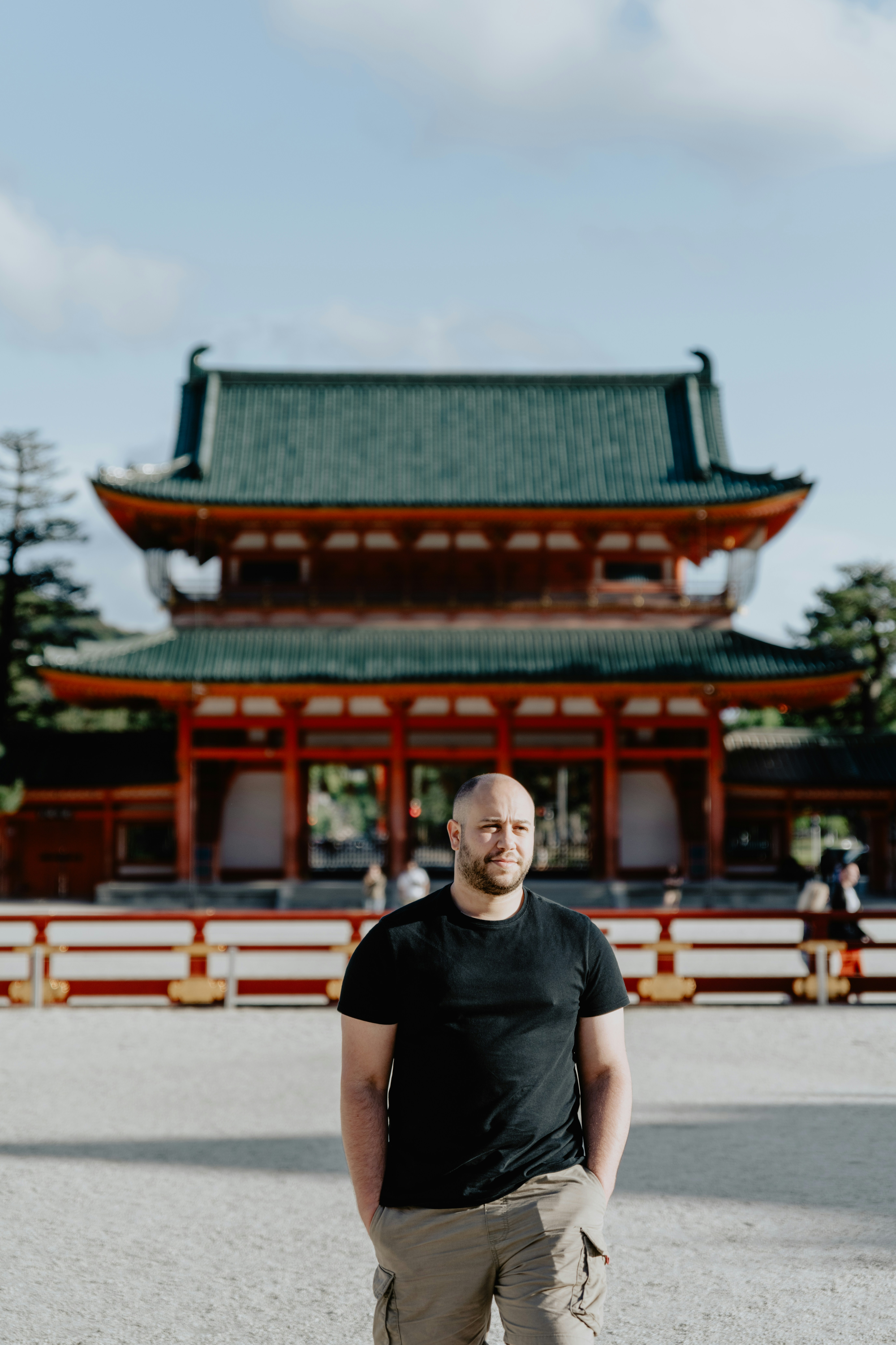 a man standing in front of a tall building