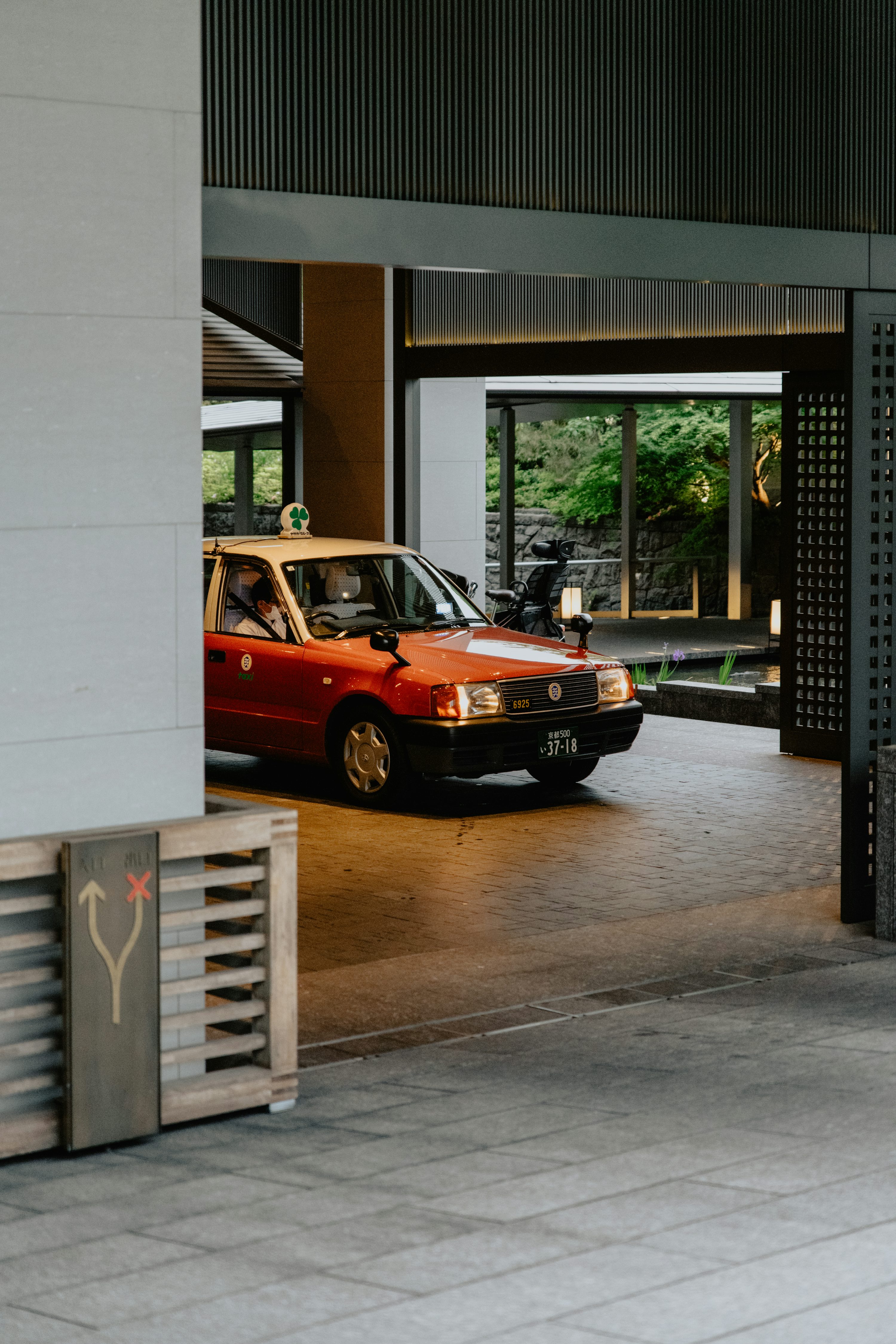 a red car is parked in a parking garage