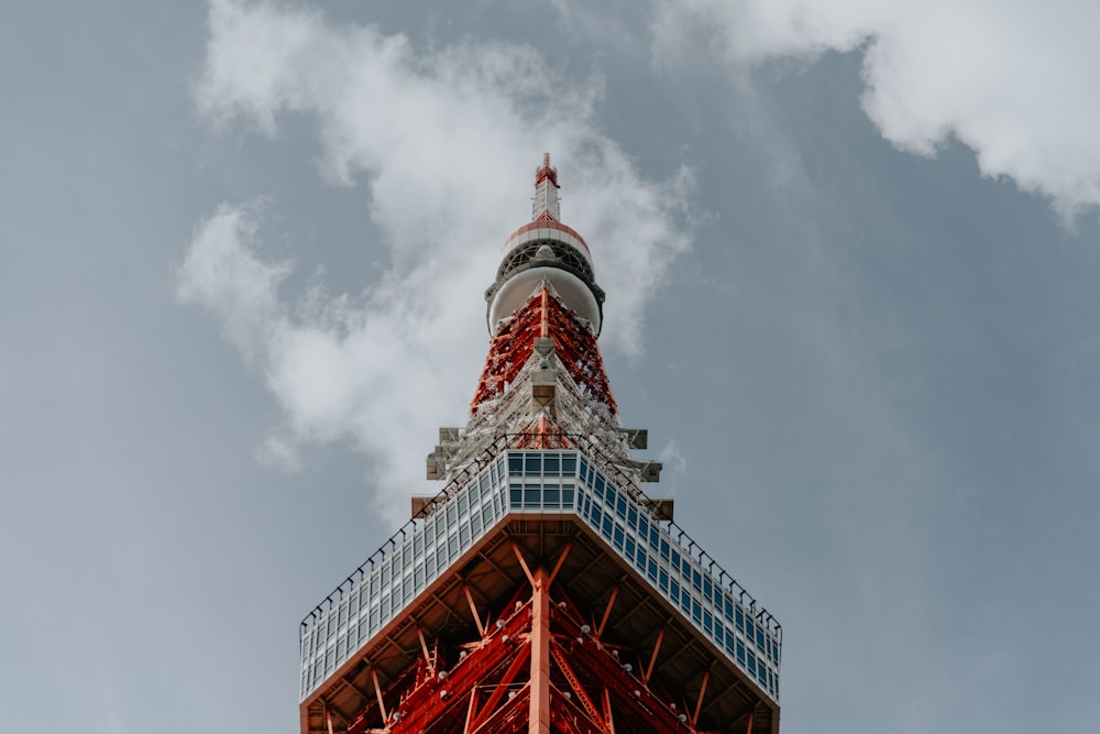 a red and white tower with a sky background