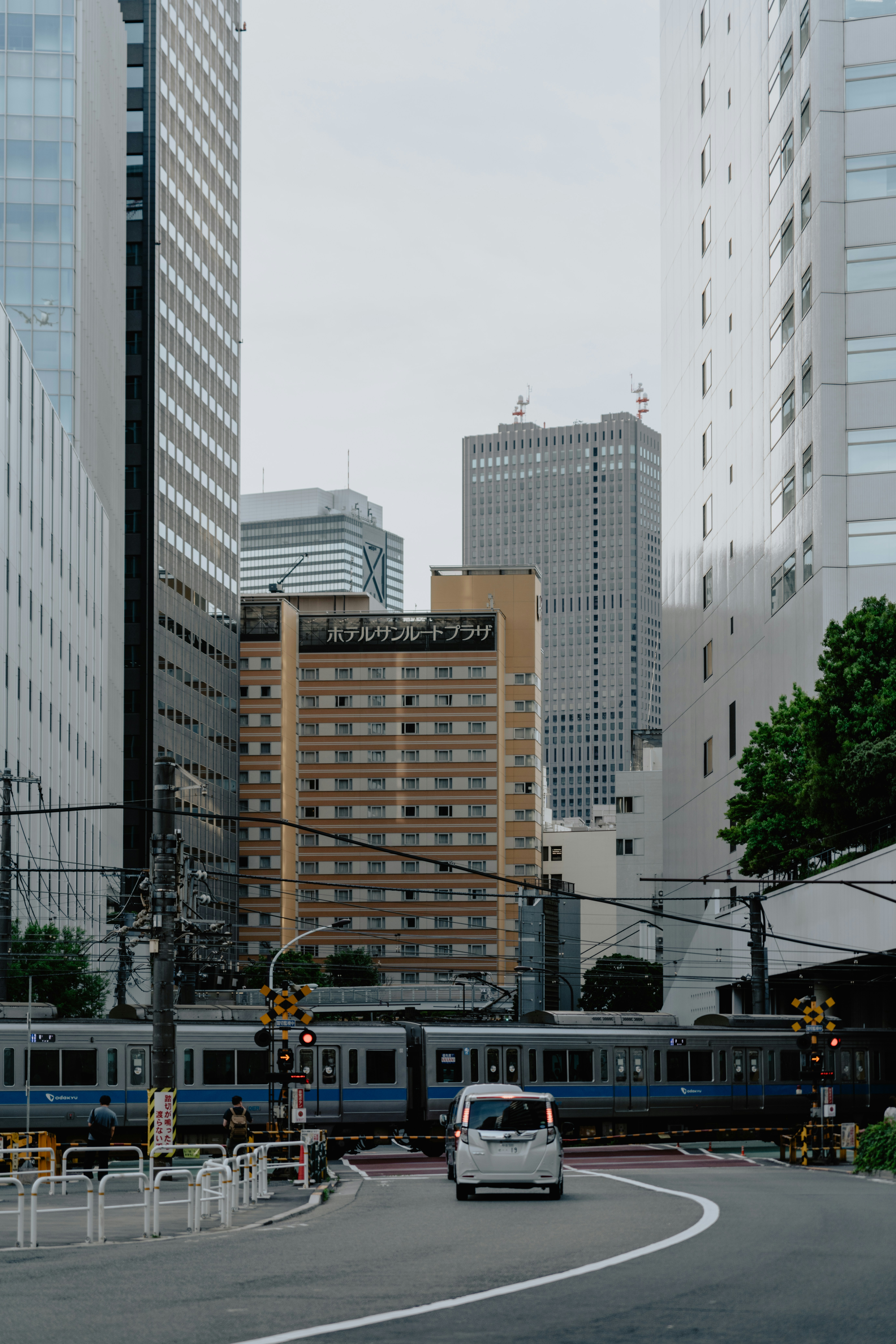 A train traveling through a city next to tall buildings photo – Free ...