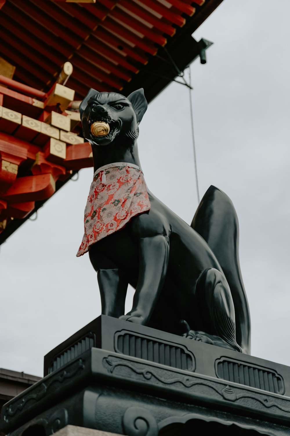 a statue of a cat on top of a building