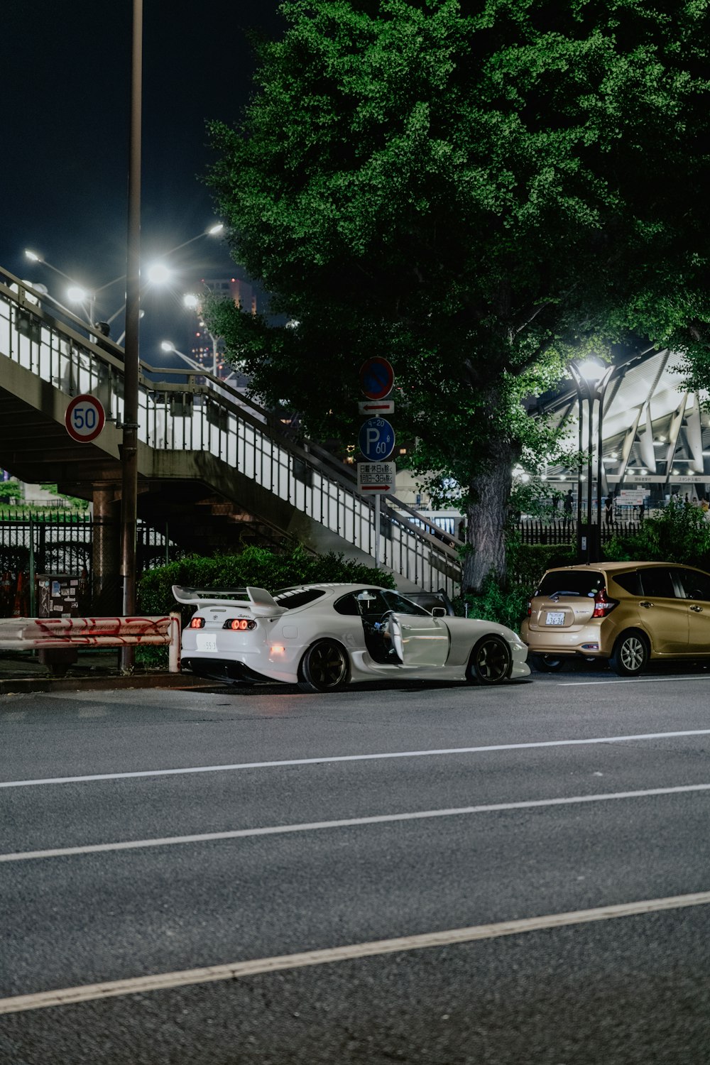 a couple of cars parked next to each other on a street