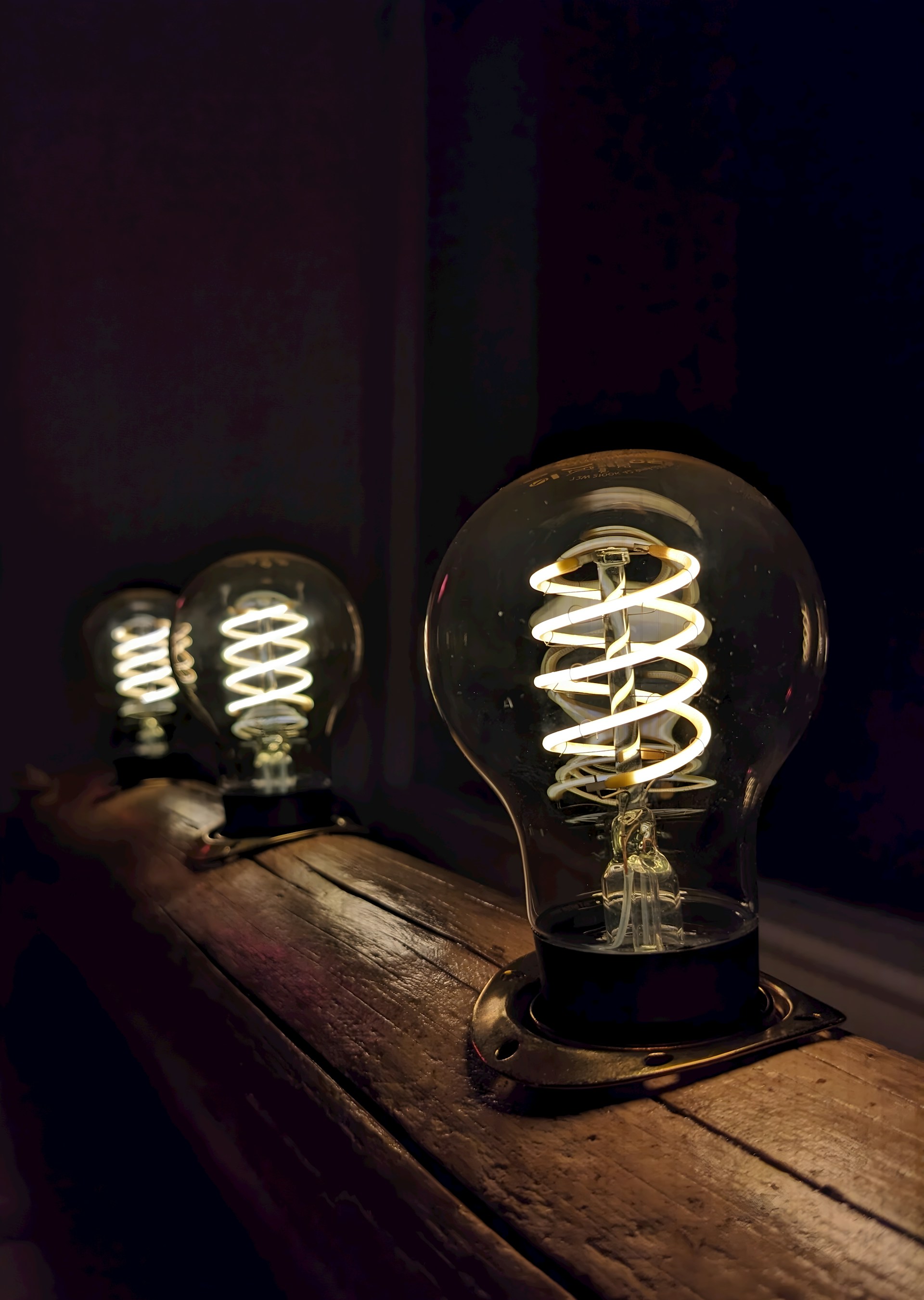 a light bulb sitting on top of a wooden table