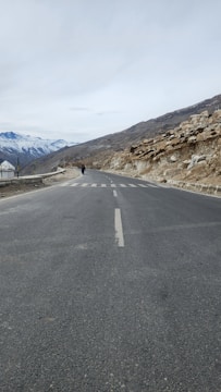 a person riding a motorcycle down the middle of a road