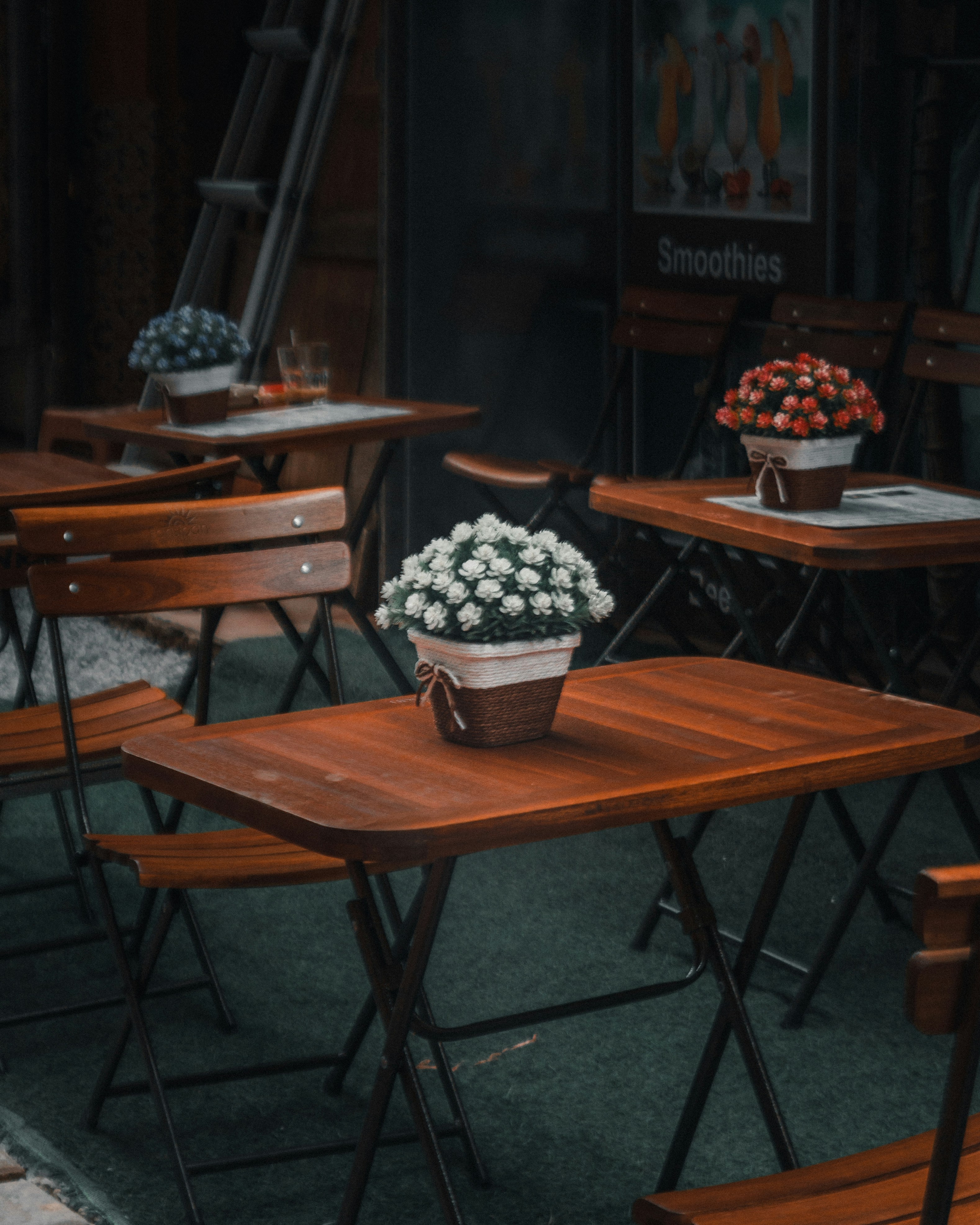a bunch of wooden tables with chairs around them
