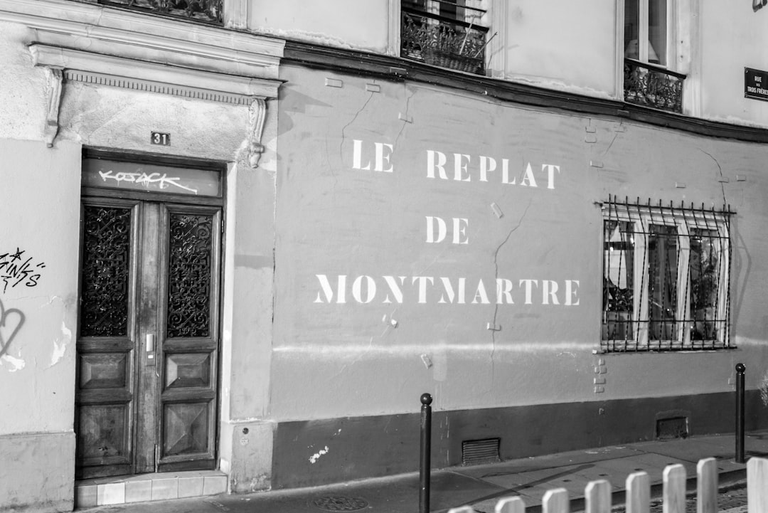 a black and white photo of a building with graffiti on it,