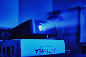 a projector sitting on top of a white box