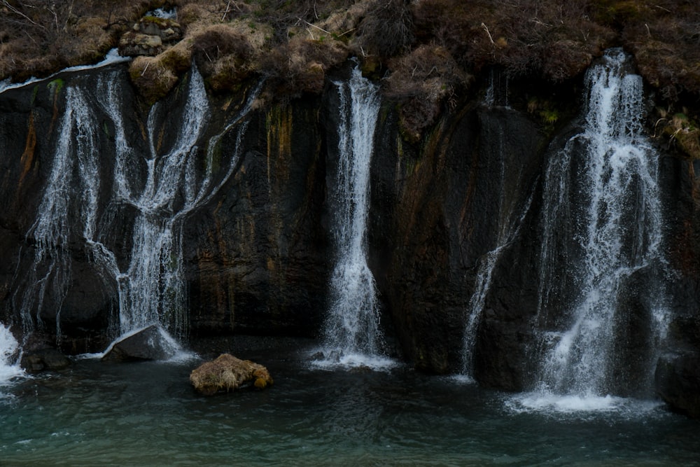 a group of waterfalls in a body of water