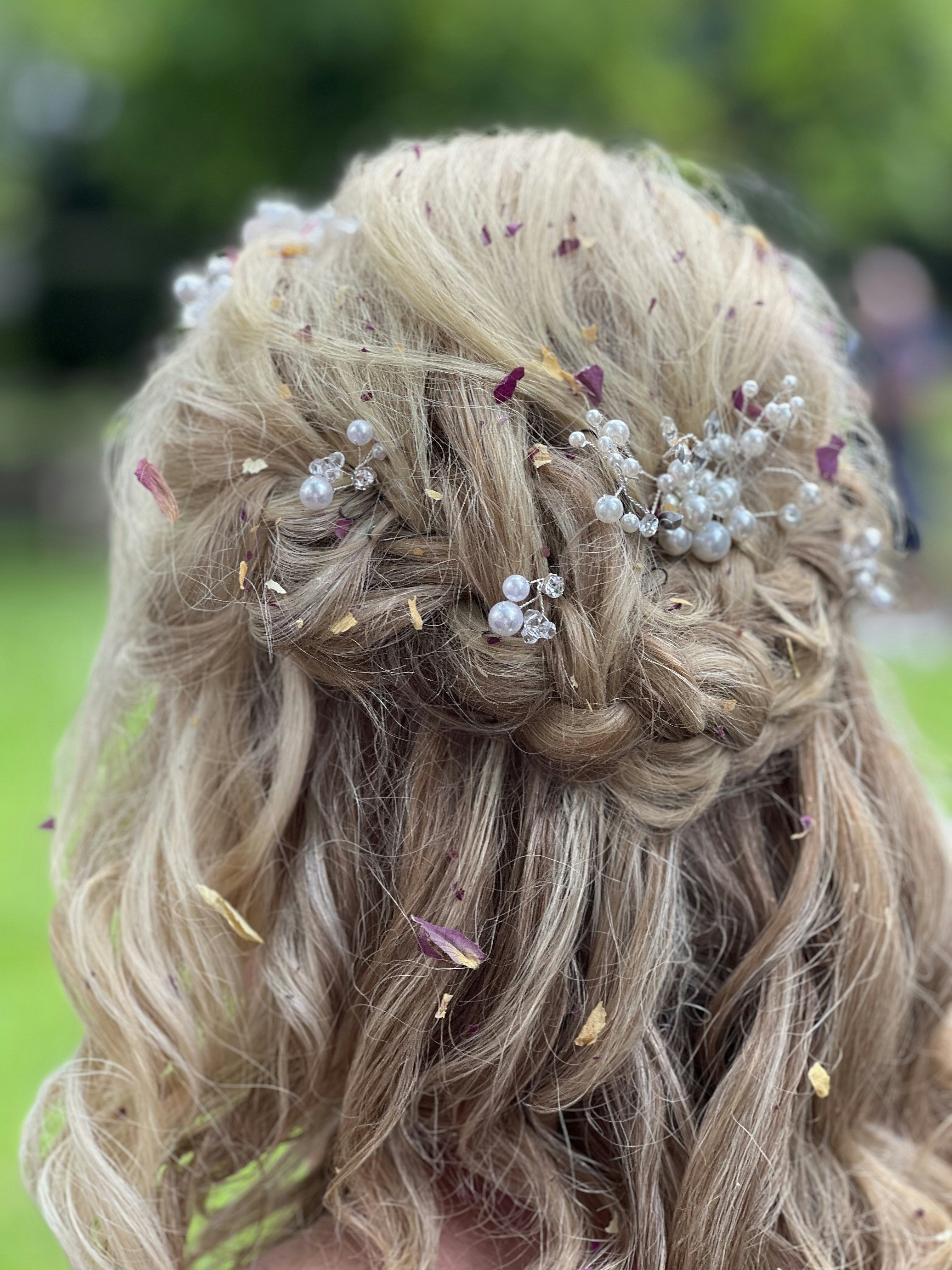 a close up of a woman's hair with flowers in it