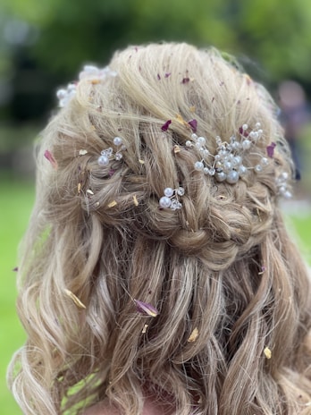 a close up of a woman's hair with flowers in it
