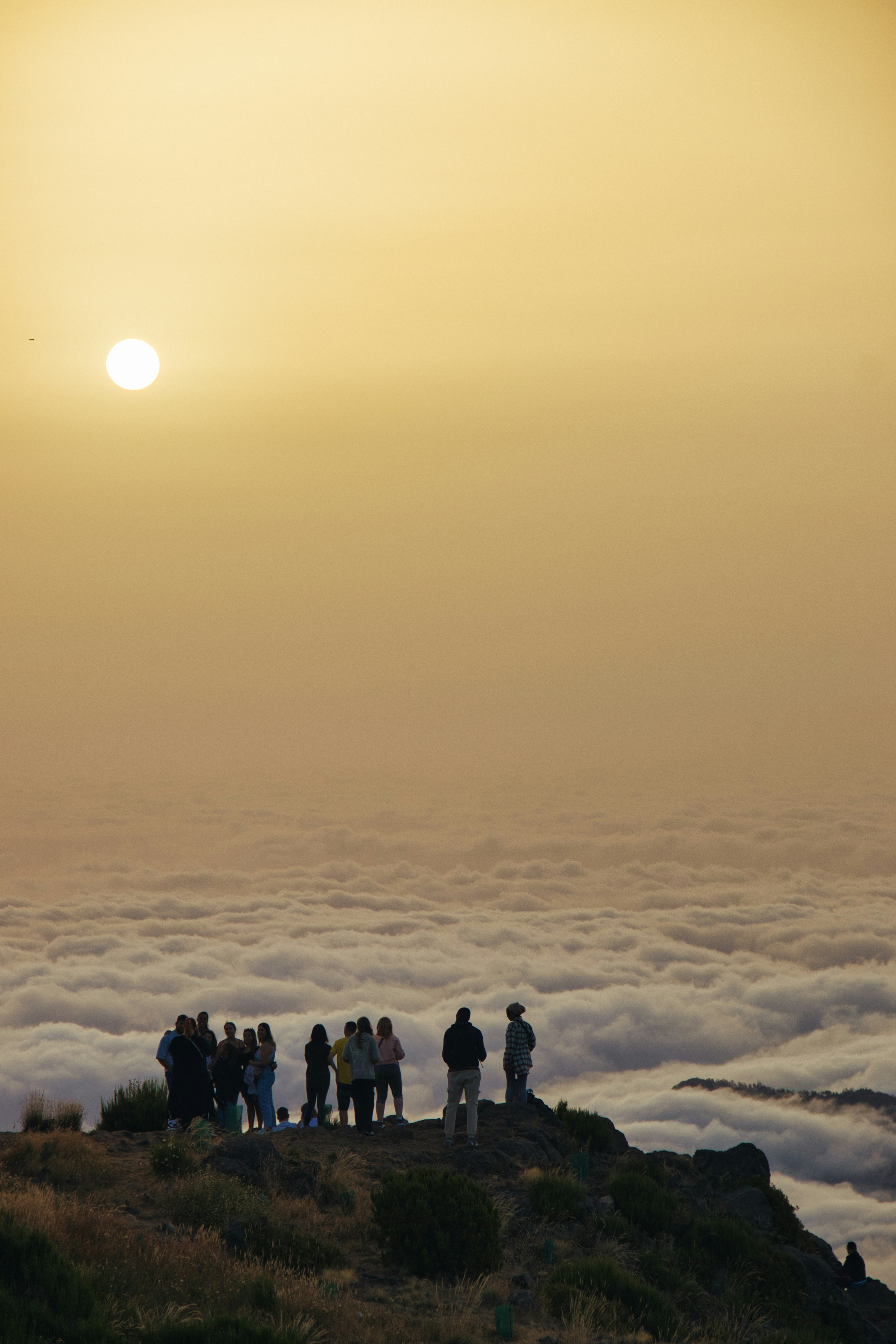 a group of people standing on top of a mountain