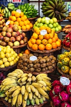 a fruit stand with bananas, oranges, pineapples, and other fruits