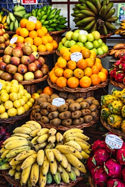 a fruit stand with bananas, oranges, pineapples, and other fruits
