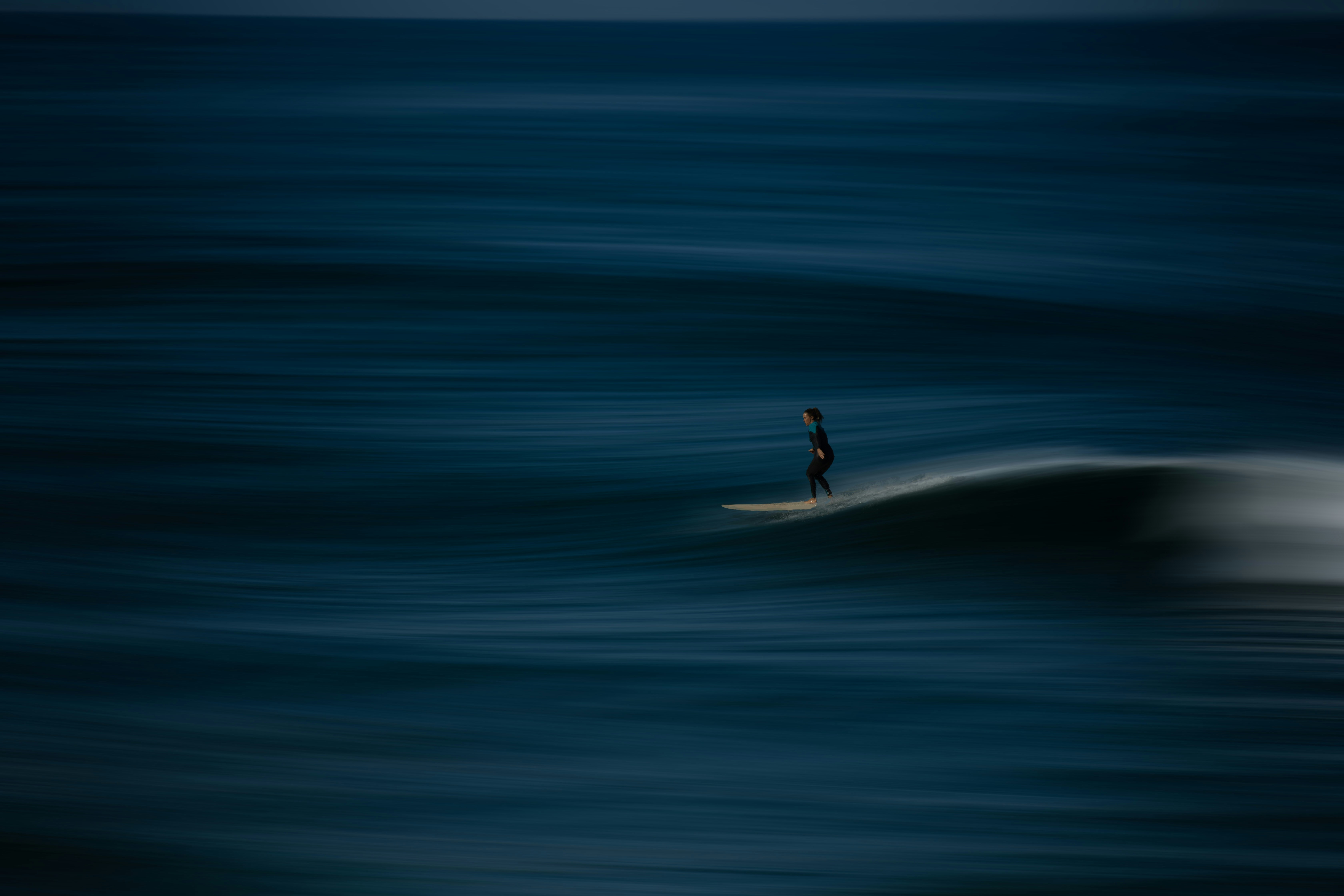 A man riding a wave on top of a surfboard photo – Free Grey Image on ...