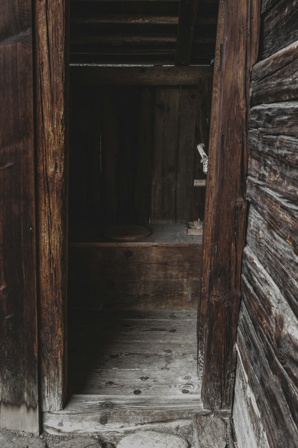 an open door leading to a wooden building