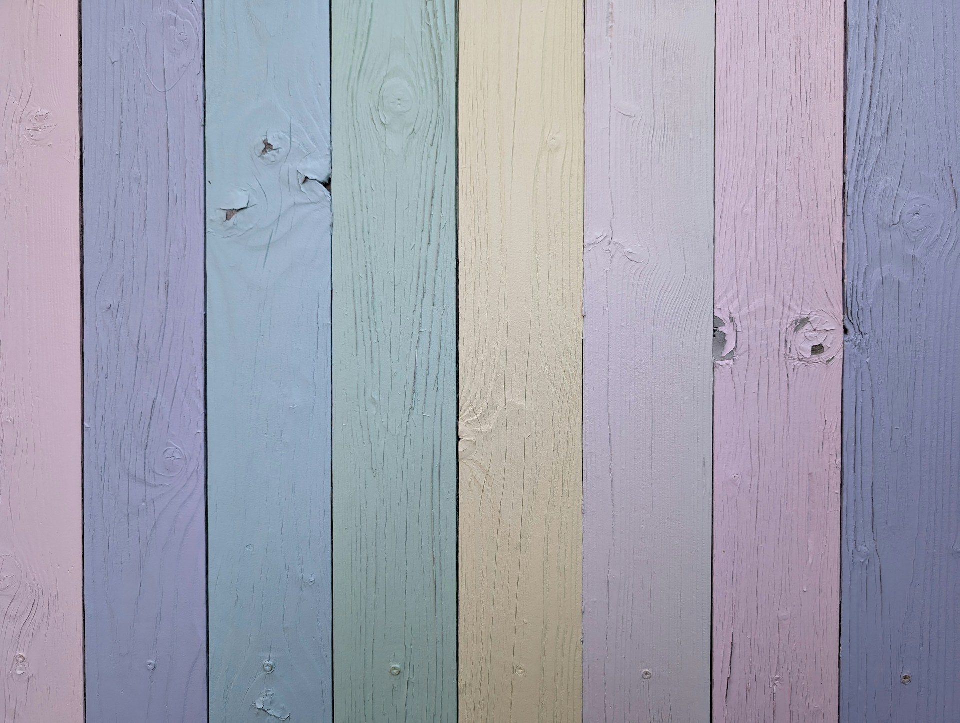 a close up of a multicolored wooden fence