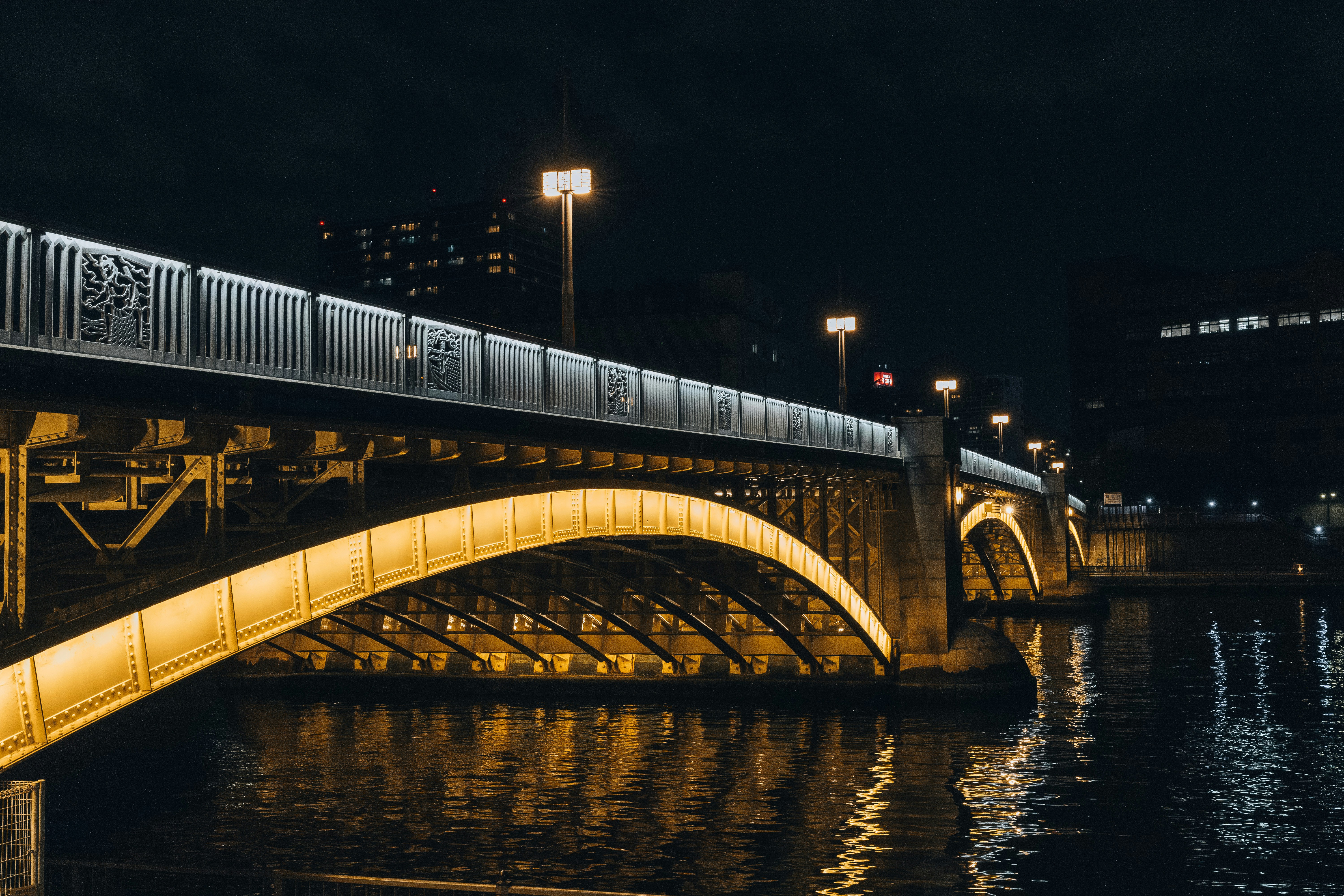 Nighttime shot of a lit bridge in Tokyo