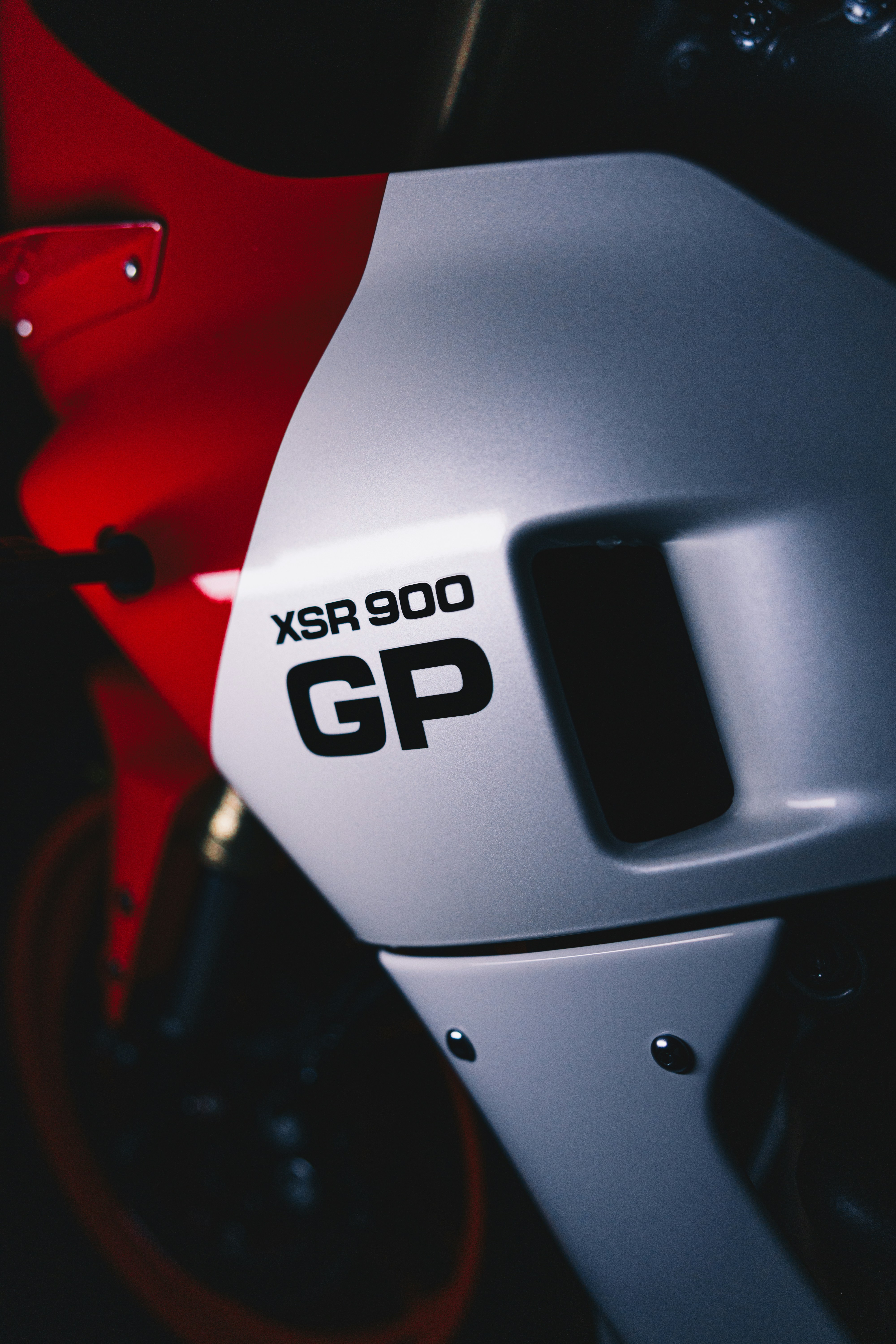 a close up of a red and white motorcycle