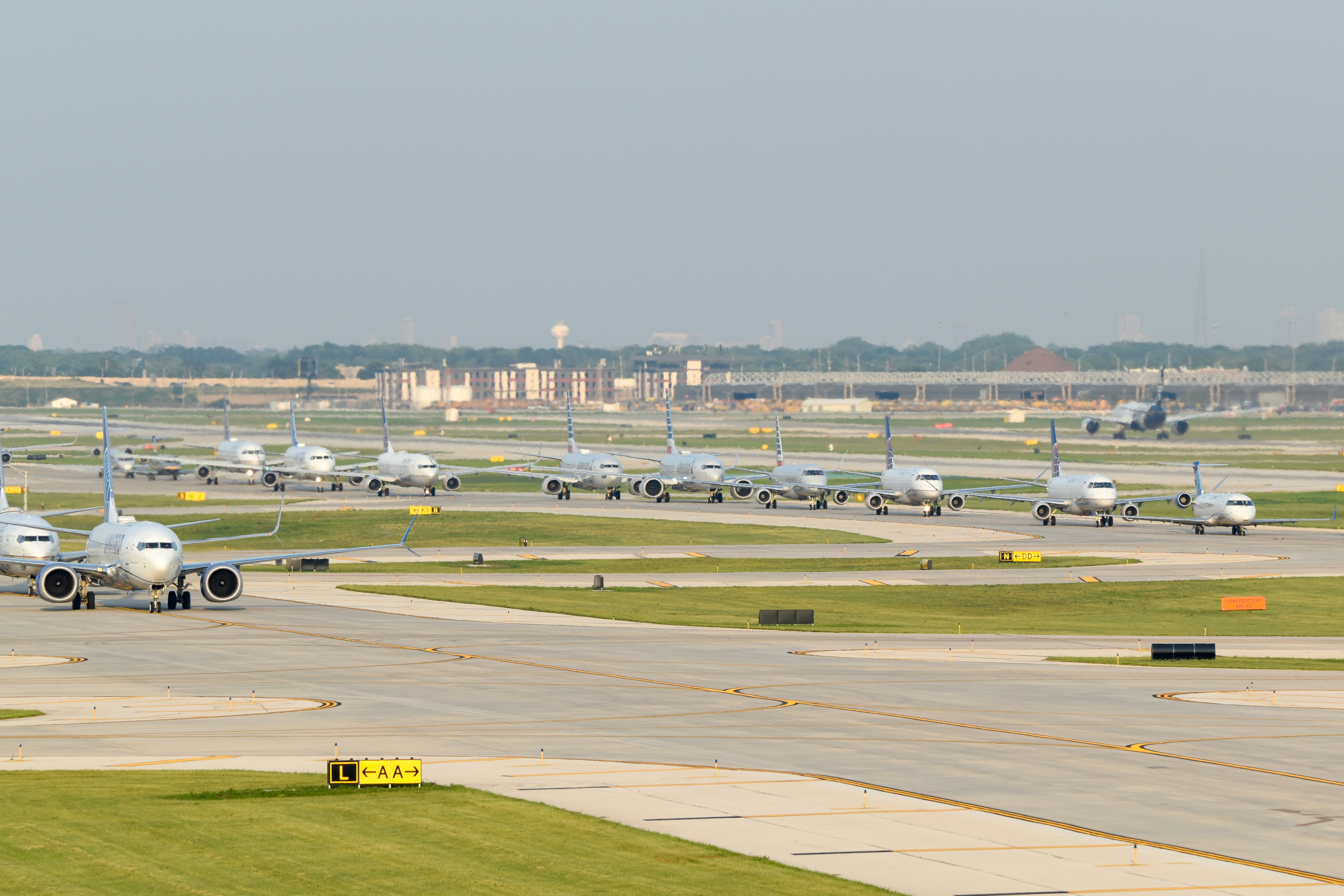 a group of airplanes parked on an airport runway, Planes lining up at Chicago O