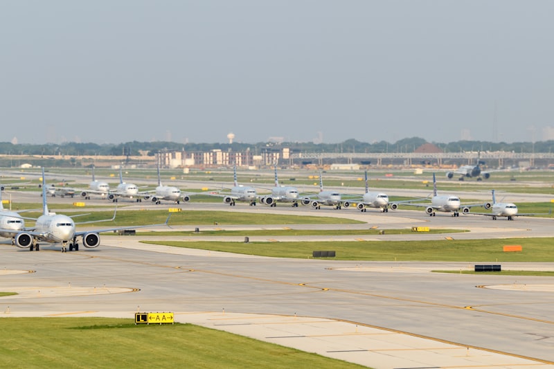 A group of airplanes parked on an airport runway