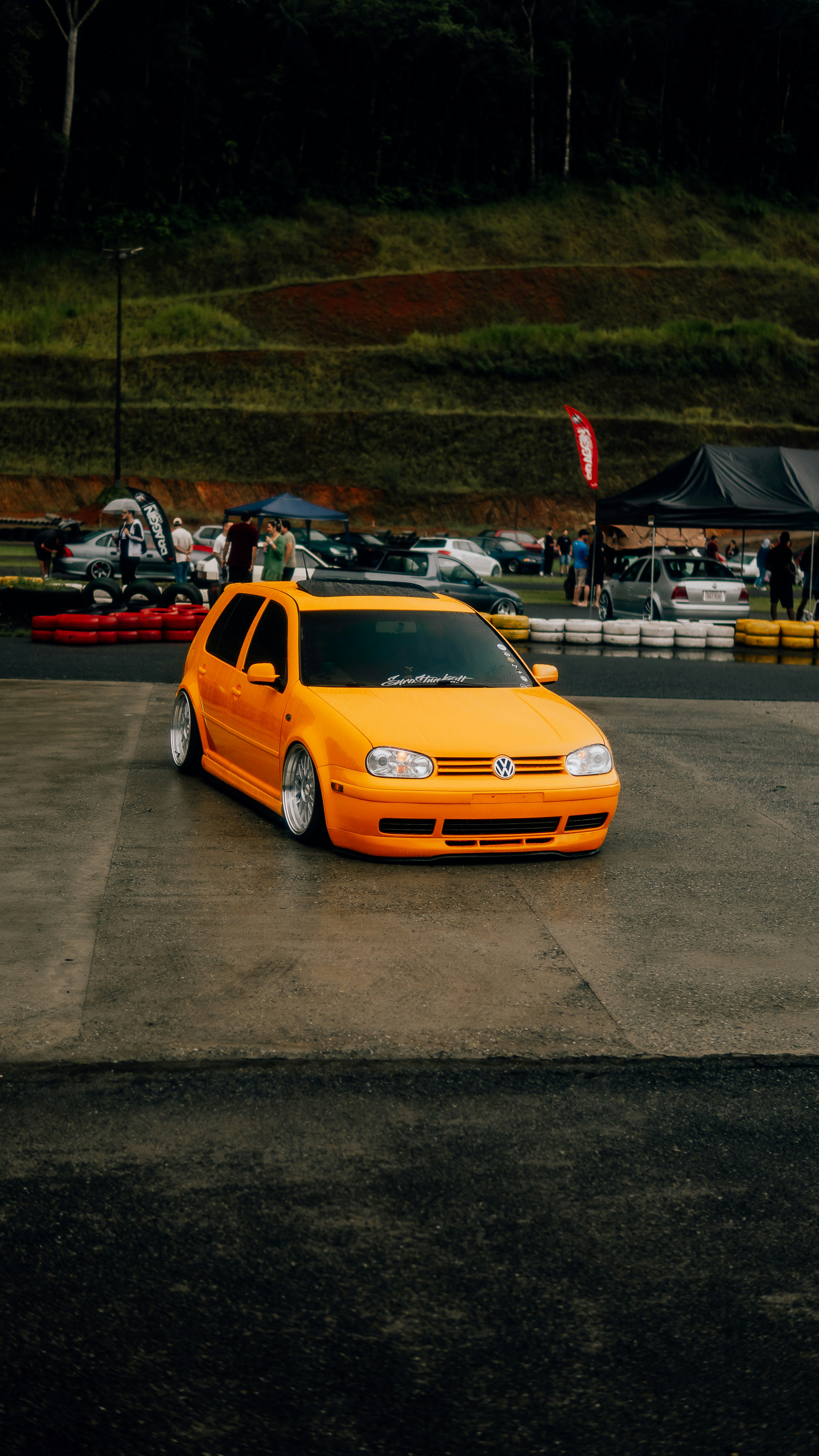 a yellow car is parked in a parking lot