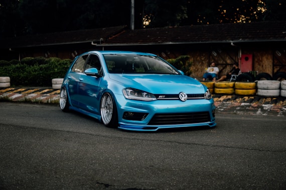 a blue car parked on the side of a road
