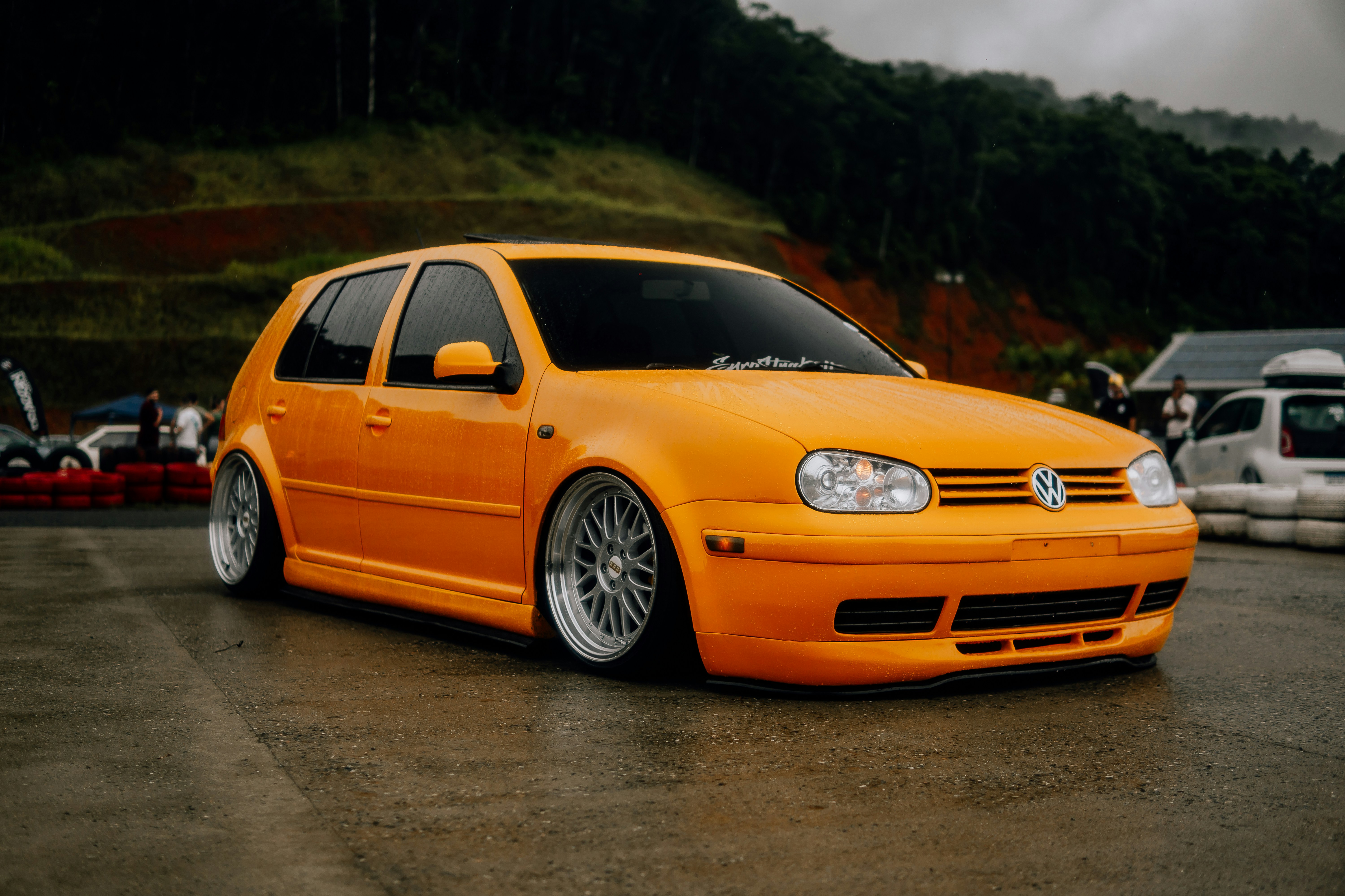 an orange car parked in a parking lot