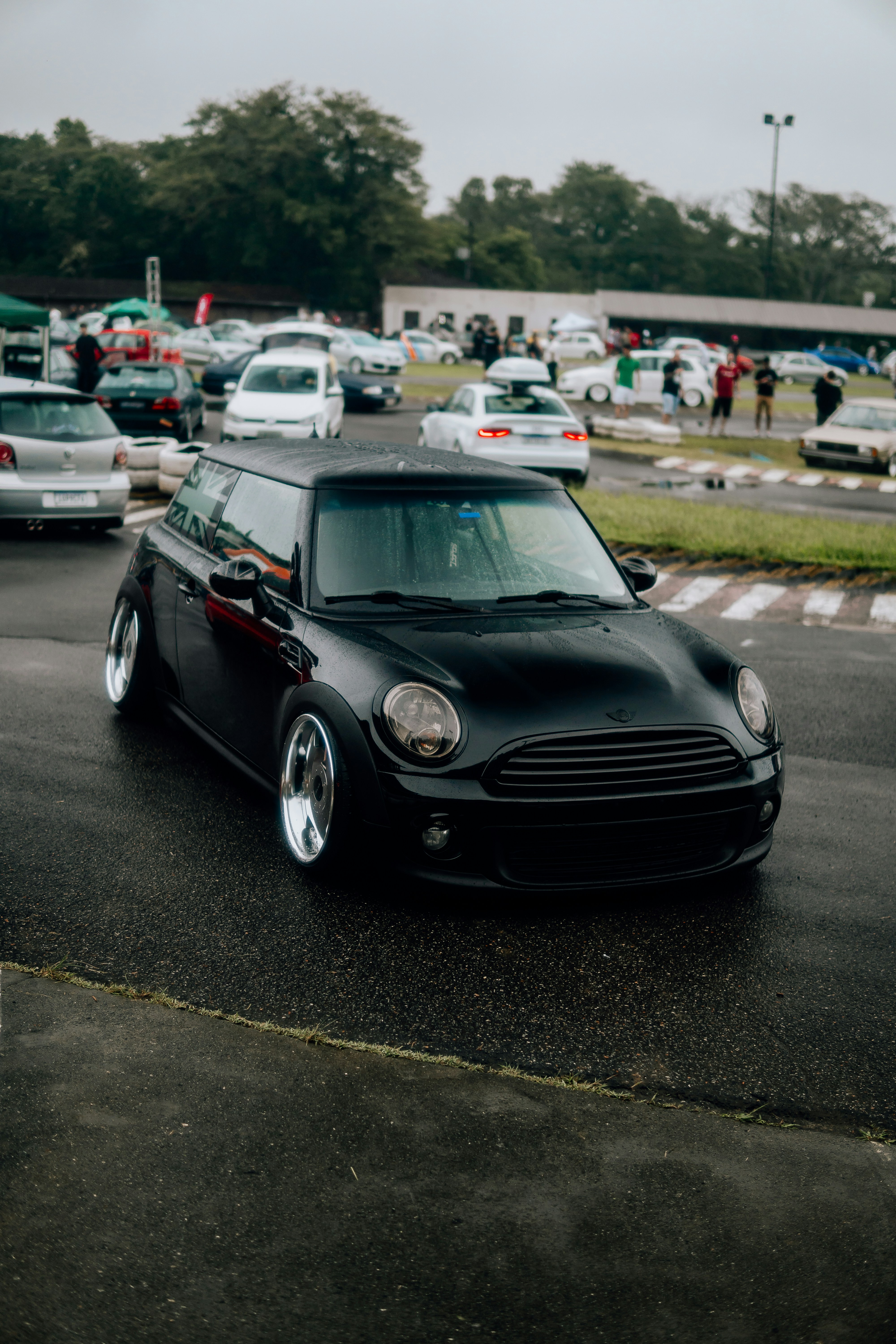 a small black car parked in a parking lot