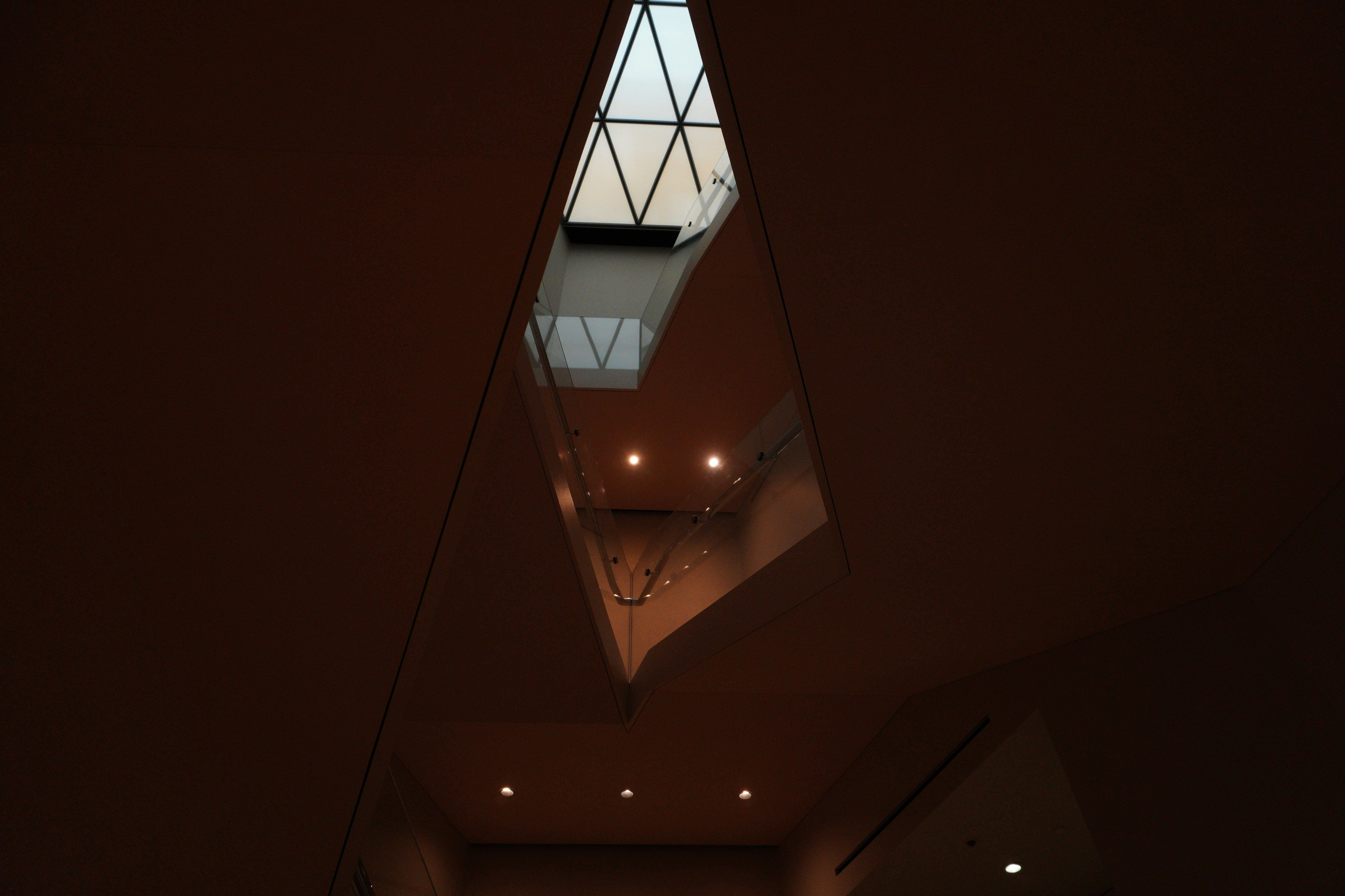 a long hallway with a skylight hanging from the ceiling