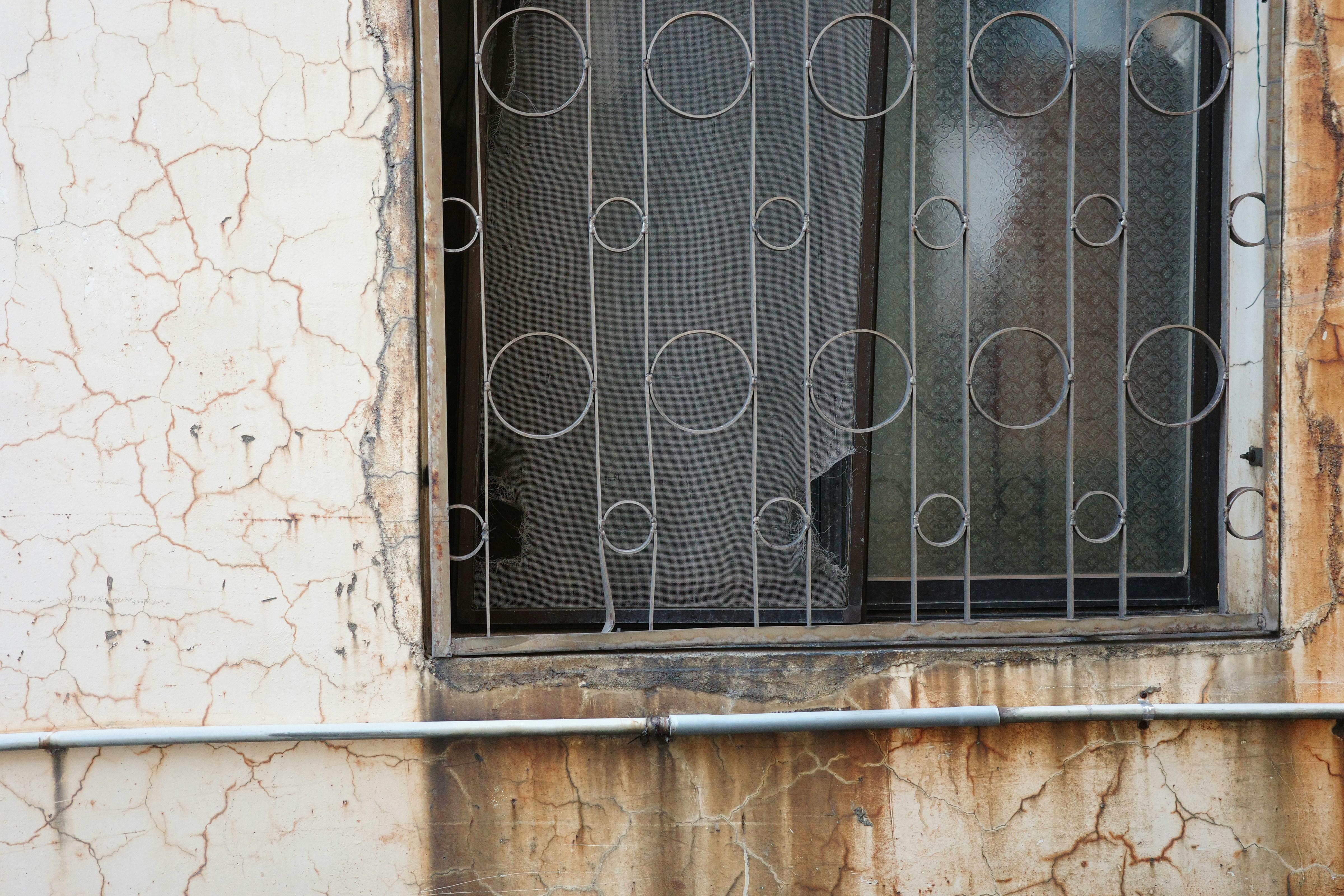 a window with bars on the outside of it