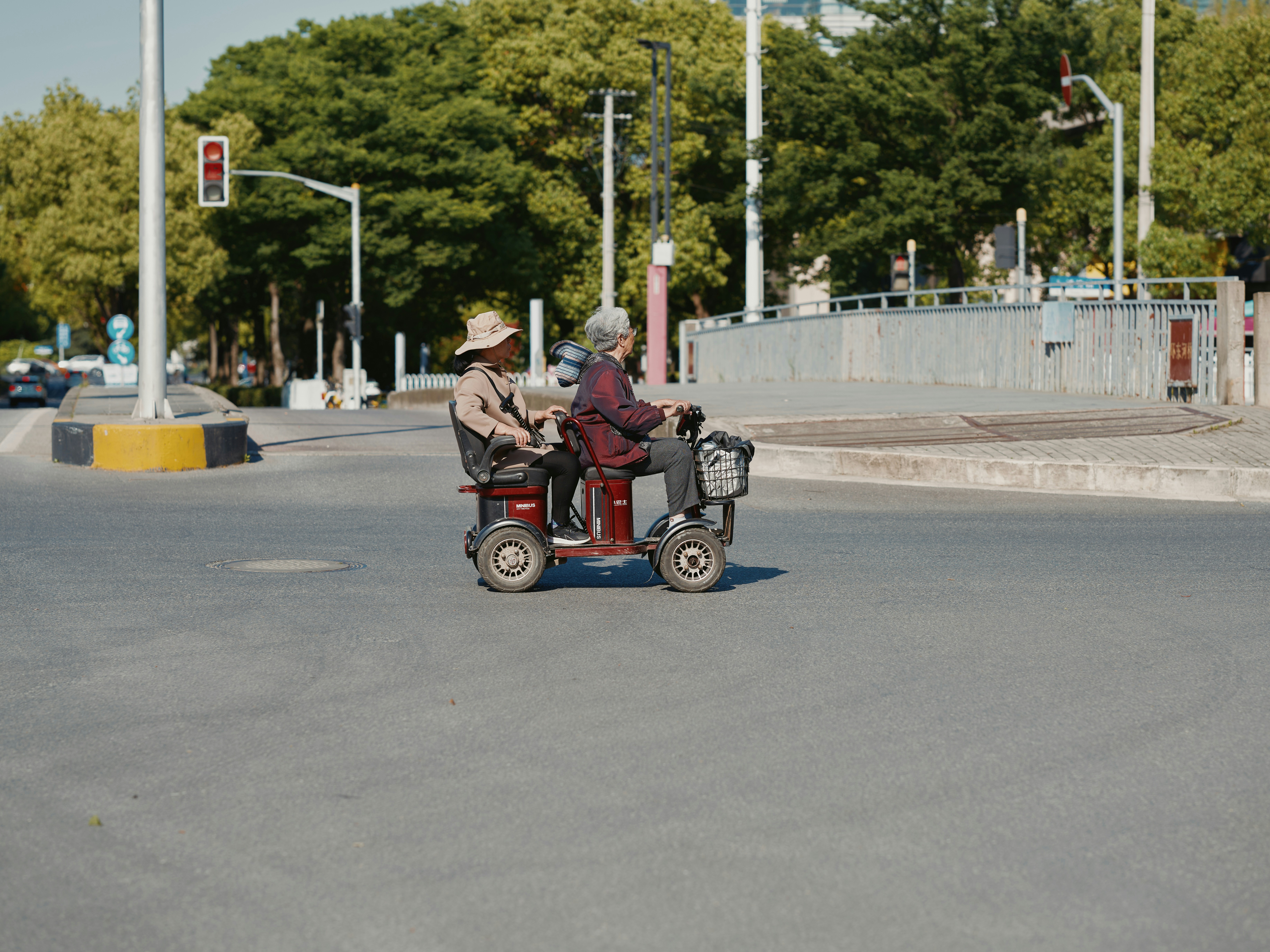 a couple of people riding on the back of a scooter