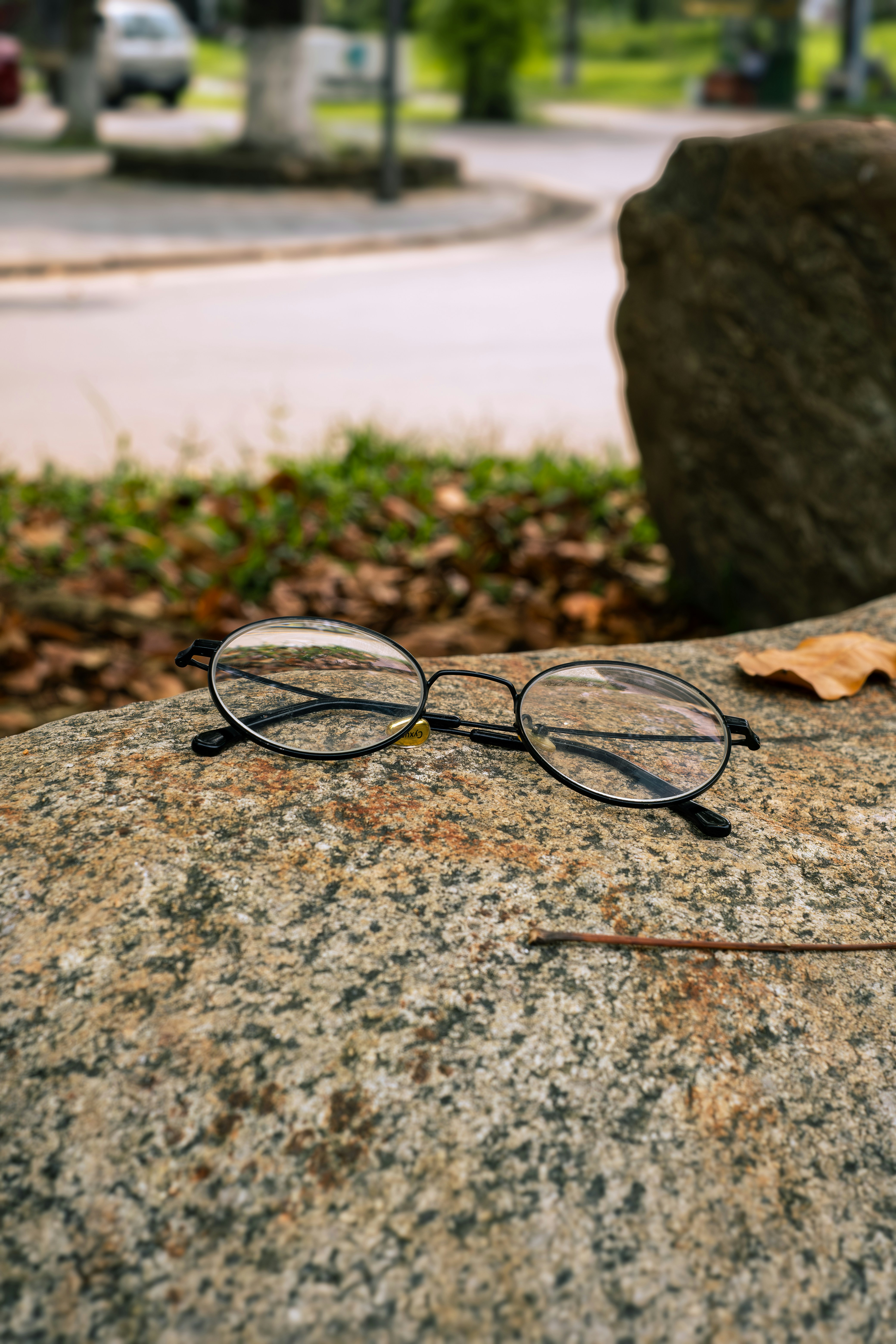 a pair of glasses sitting on top of a rock