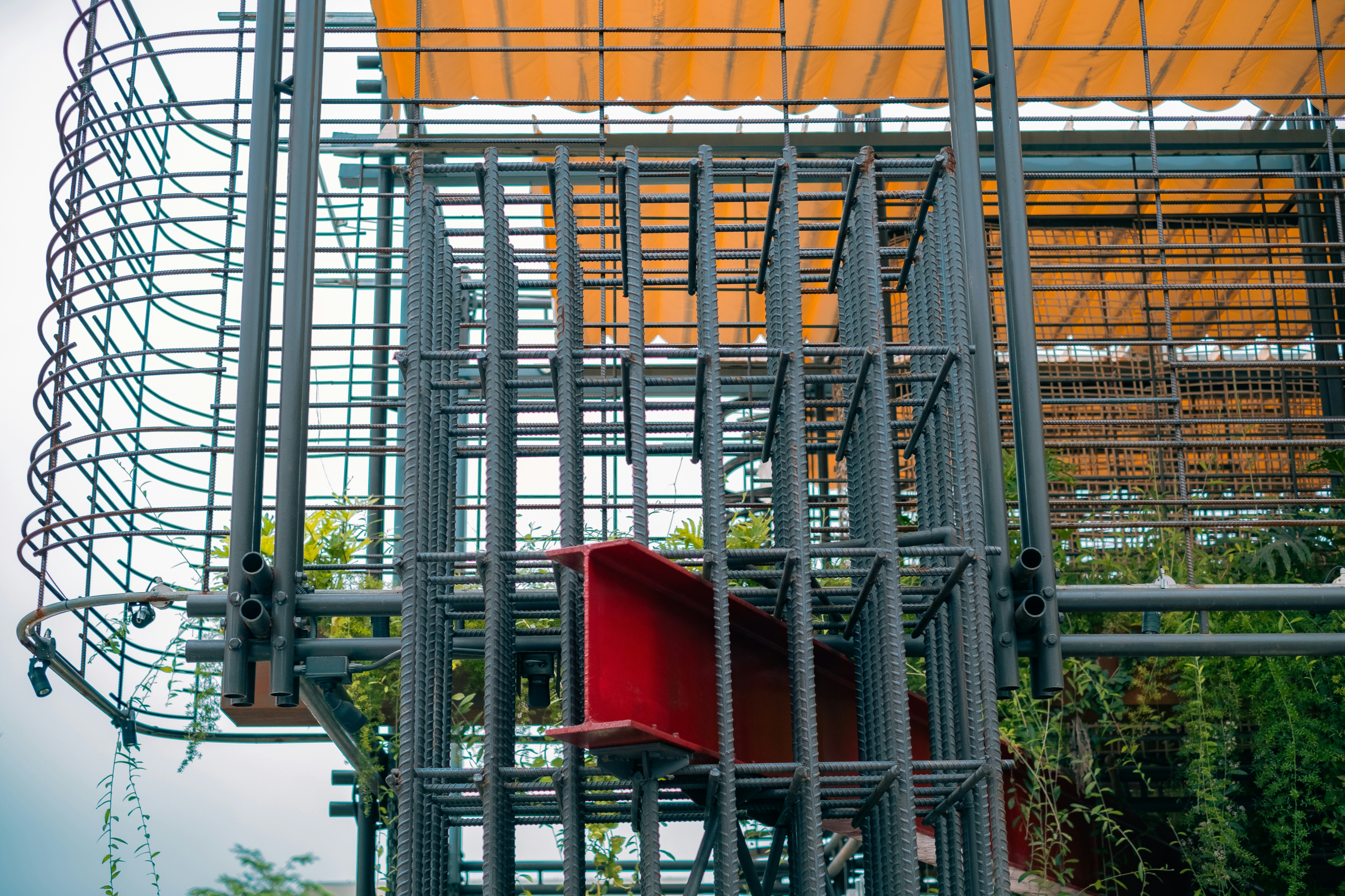 a red object sitting on top of a metal structure
