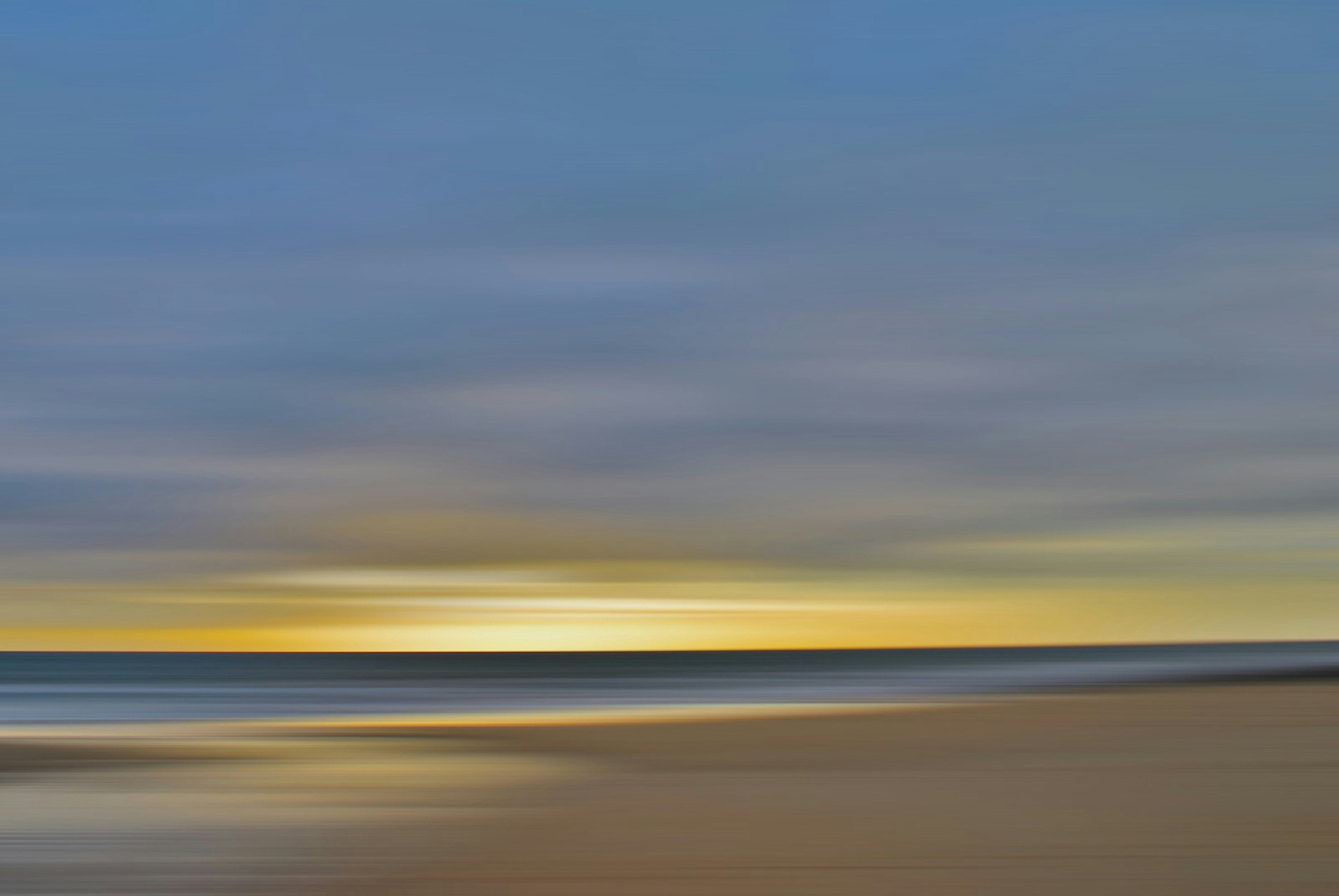 a blurry photo of a beach at sunset