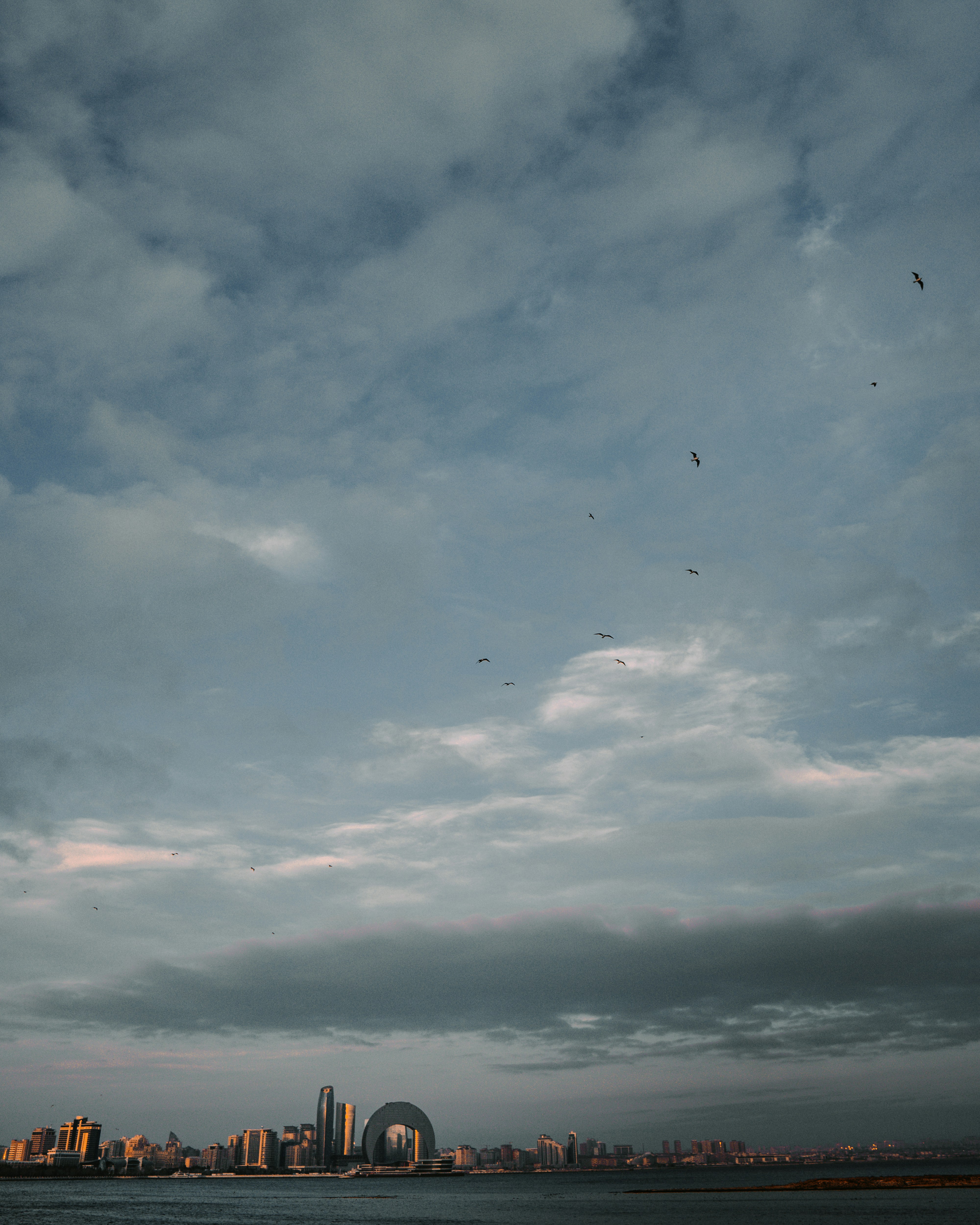 a large body of water with a city in the background