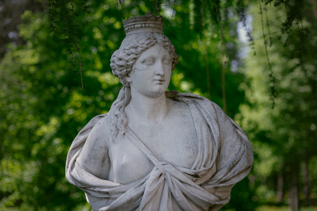 Antique bust against a background of green foliage