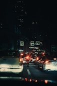 a city street filled with lots of traffic at night