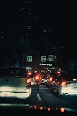 a city street filled with lots of traffic at night