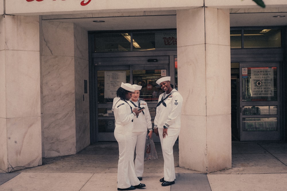 a couple of people that are standing in front of a building