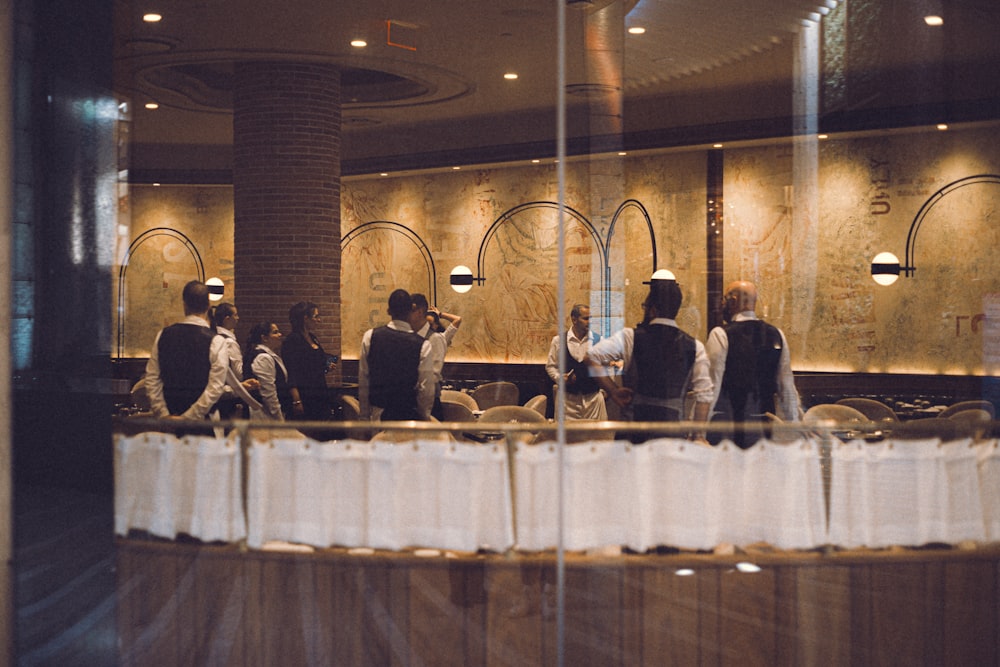 a group of people sitting at a table in a restaurant