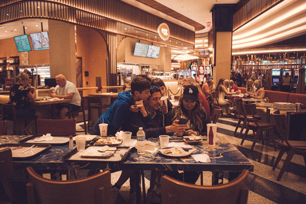 a group of people sitting at a table in a restaurant