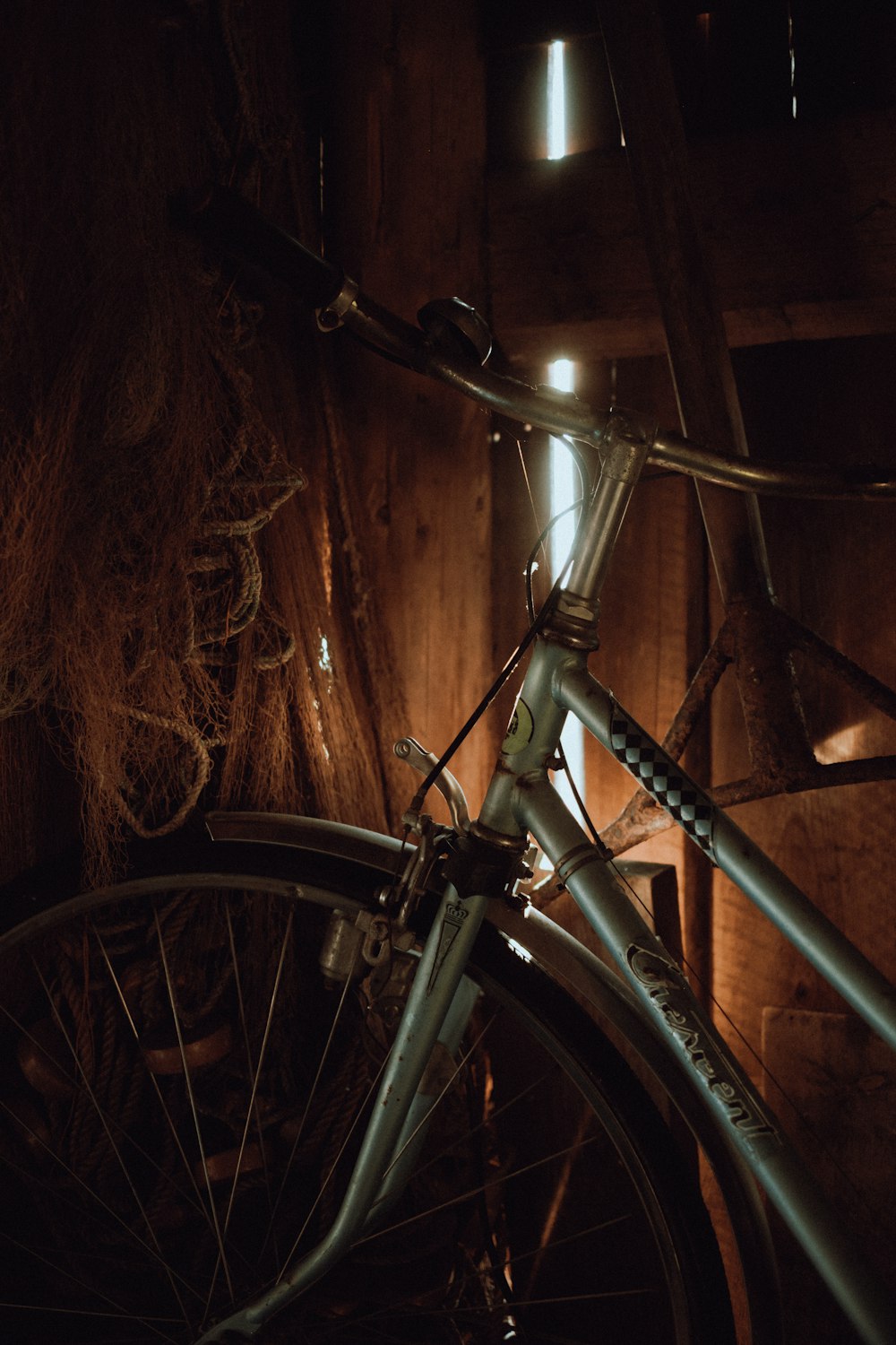a close up of a bike parked in a barn