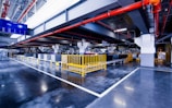 a large industrial building with a yellow gate