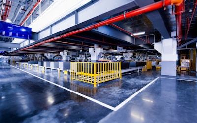 a large industrial building with a yellow gate