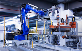 blue industrial robot arm in factory
